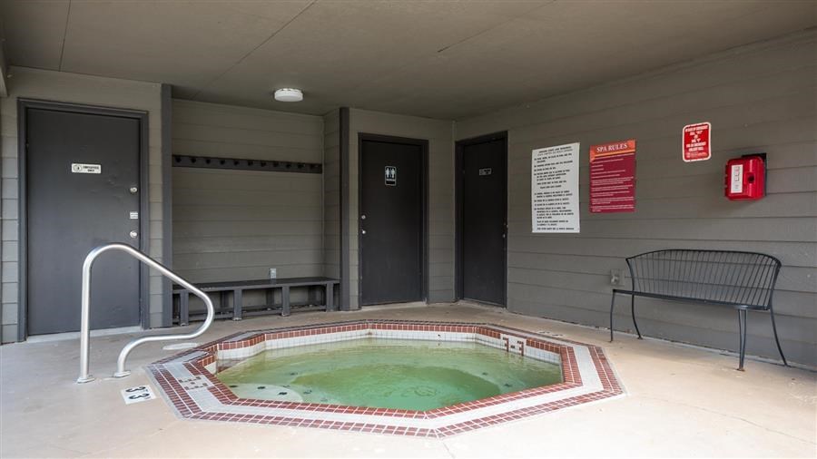 a small pool of water in a room with a chair