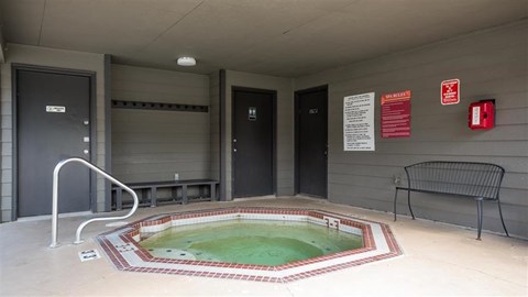 a small pool of water in a room with a chair