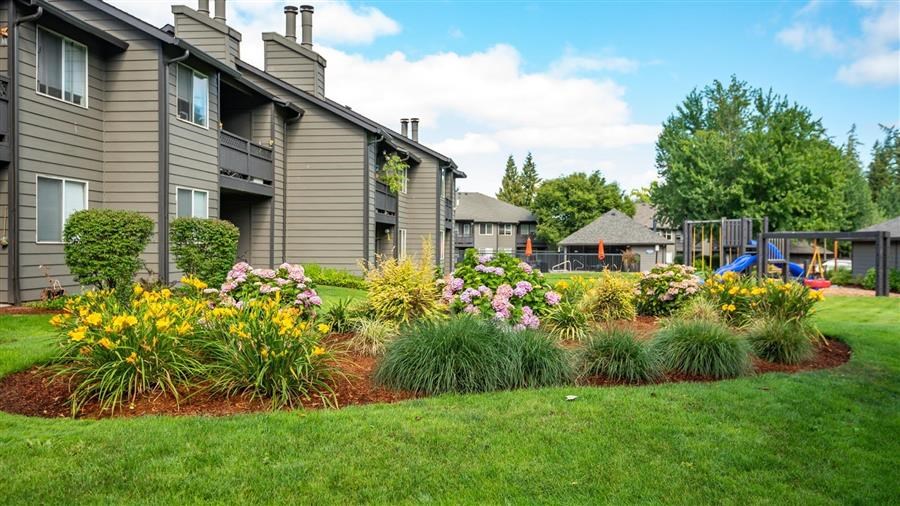 a flower garden in front of a house