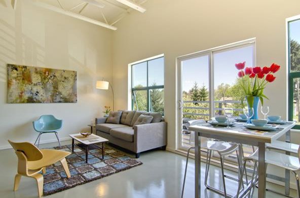 a living room and dining room with a table and chairs