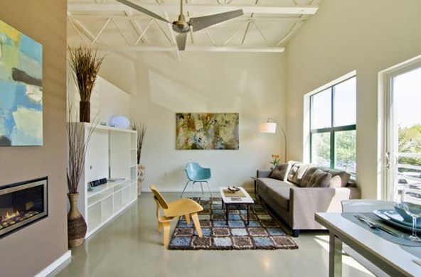 a living room with a couch and a ceiling fan