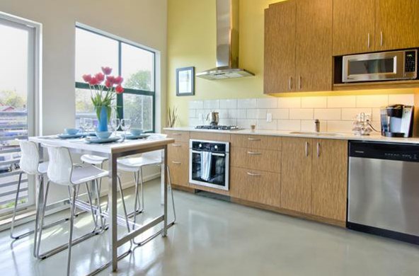 a large kitchen with a table and chairs