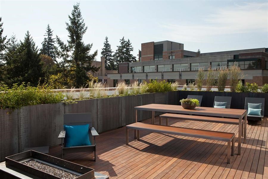 a patio with a table and chairs on a roof