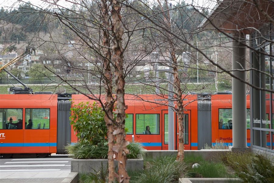a red train is parked in a train station