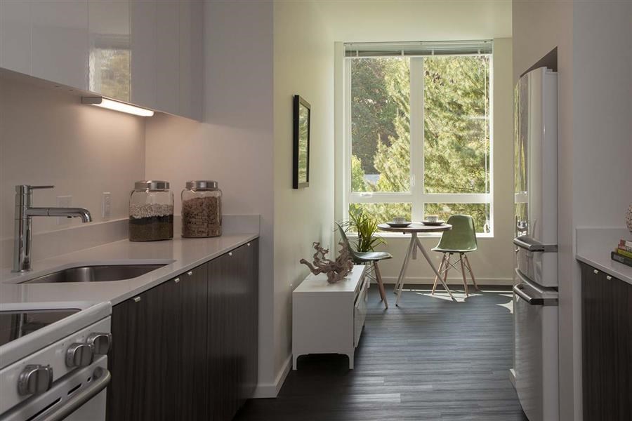 a kitchen with a sink and a large window