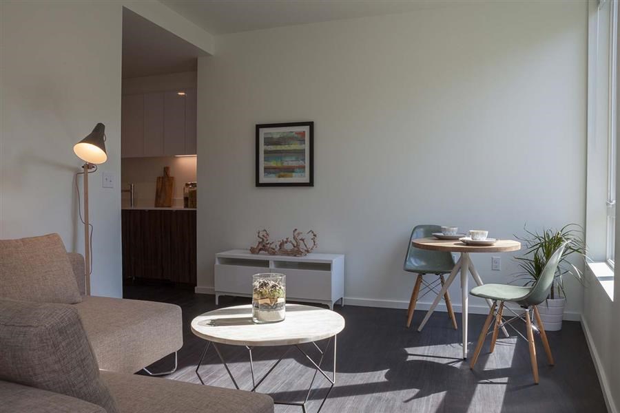 a living room with a table and a chair