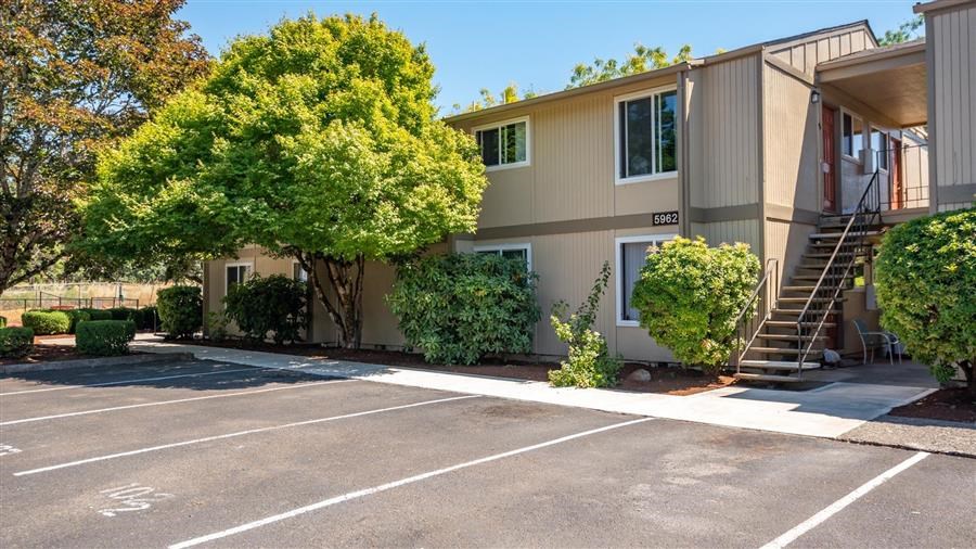 an apartment building with a parking lot and a staircase