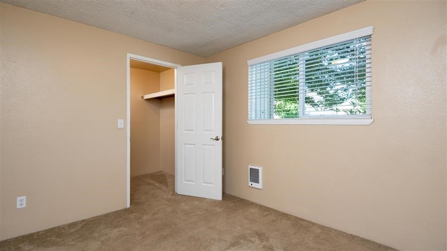 an empty room with a window and a white door
