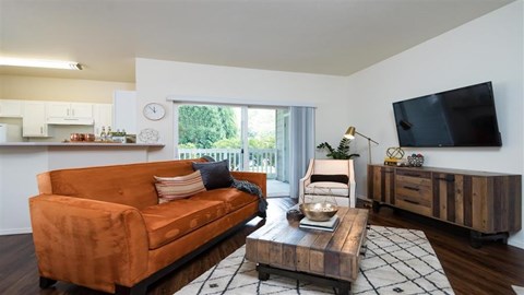 a living room with a leather couch and a television