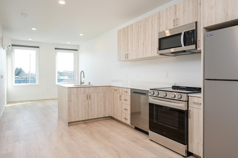 A kitchen with wooden cabinets and stainless steel appliances.