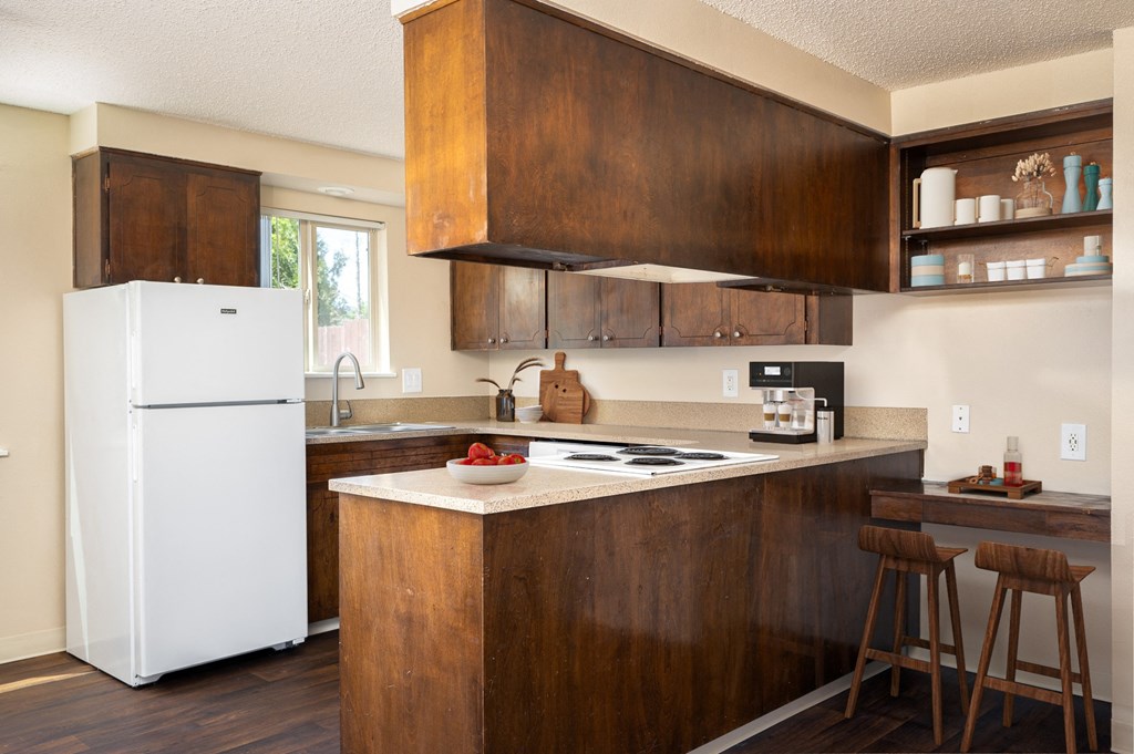 a kitchen with wooden cabinets and a white refrigerator