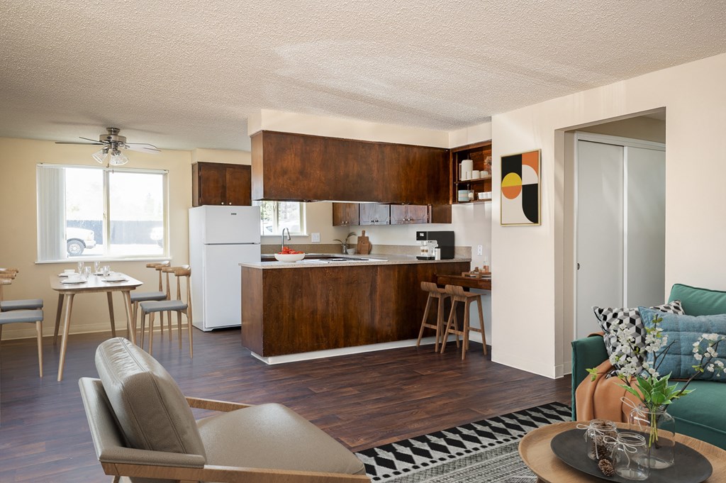 a living room and kitchen with a table and chairs