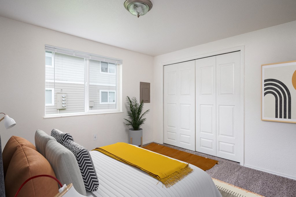 a bedroom with a bed and a window and a closet