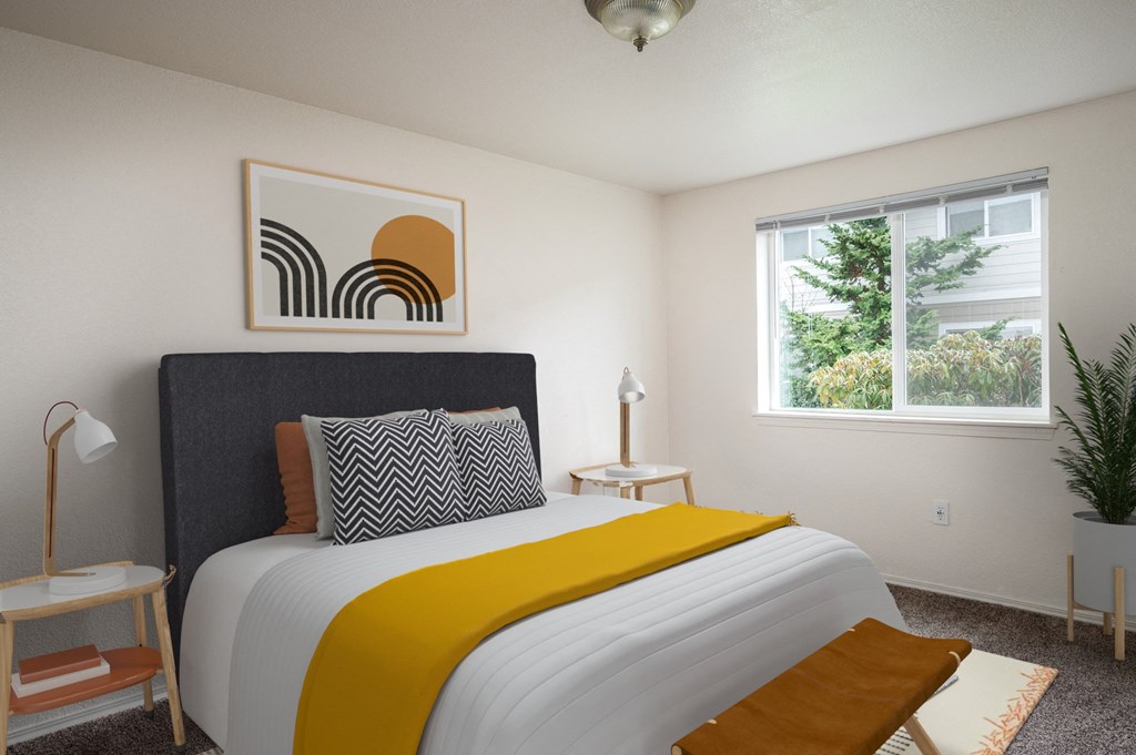 a bedroom with a large bed and two windows