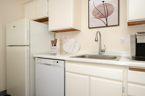 A white fridge and dishwasher in a kitchen.
