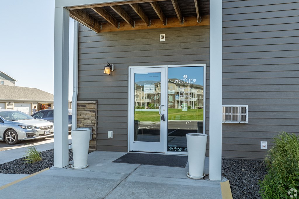 the view of the front entrance of a building with glass doors