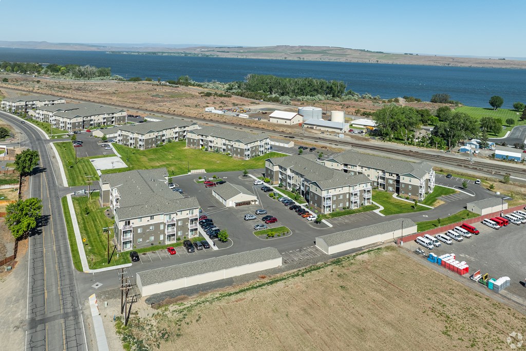 an aerial view of a city with buildings and a body of water