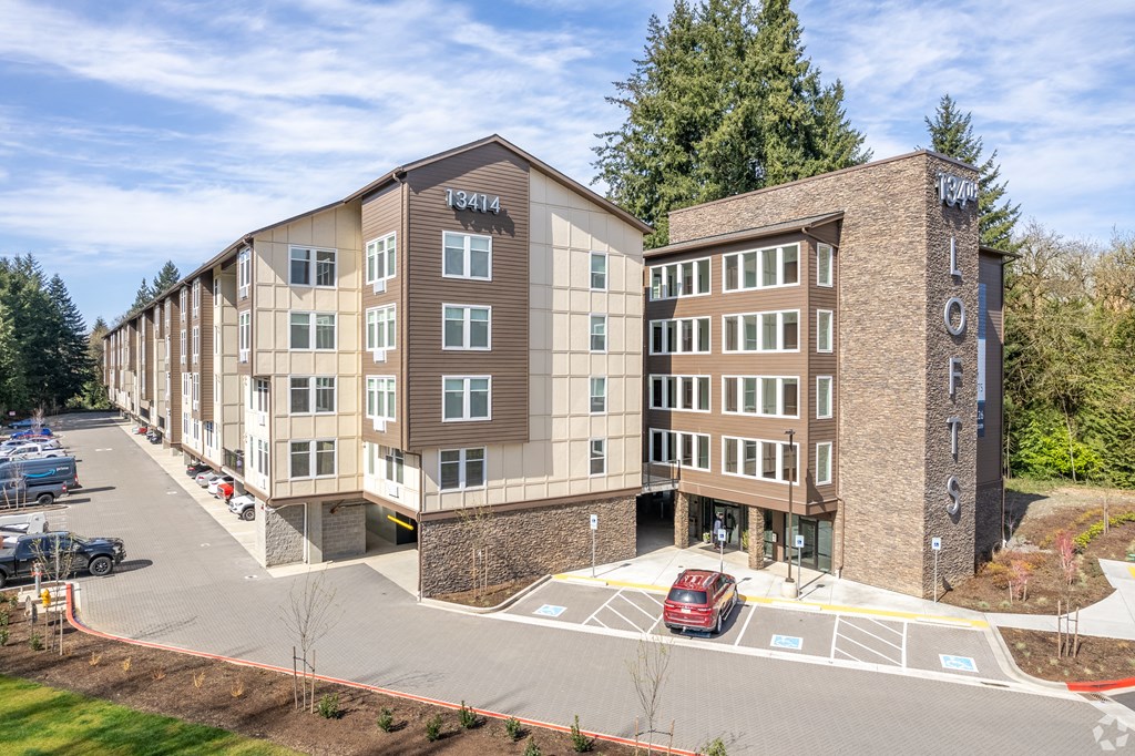 Dog-Friendly Apartments in Vancouver, WA - 134th Street Lofts - Building Exterior with a Parking Lot