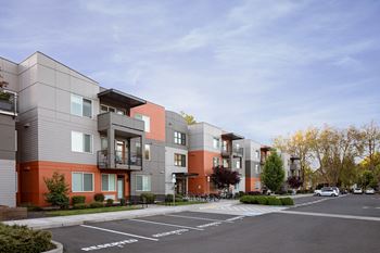 Corvallis, OR Apartments - Exterior View of The Quad near OSU - Apartments Building Surrounded By Lush Landscaping with View of Outdoor Lounge