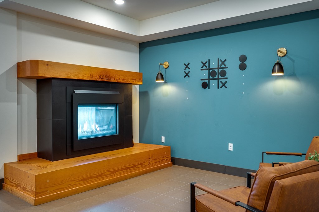 a living room with a fireplace and a blue wall