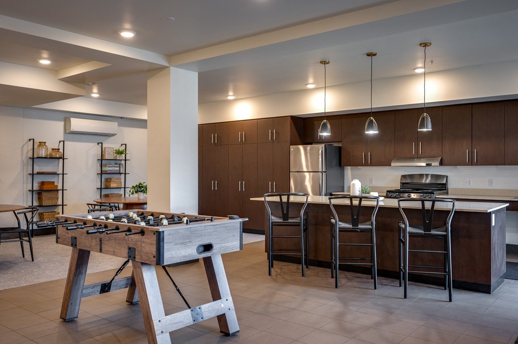 a large kitchen with a foosball table in the center of it