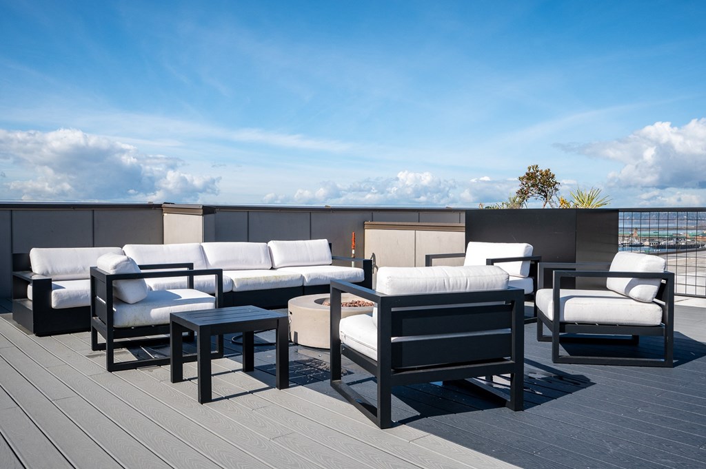 a terrace with couches and tables on a roof