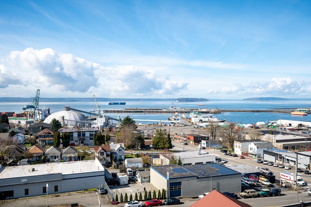 an aerial view of the city with the ocean in the background