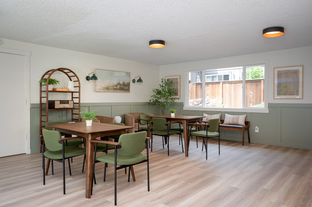 a dining room with tables and chairs and a window