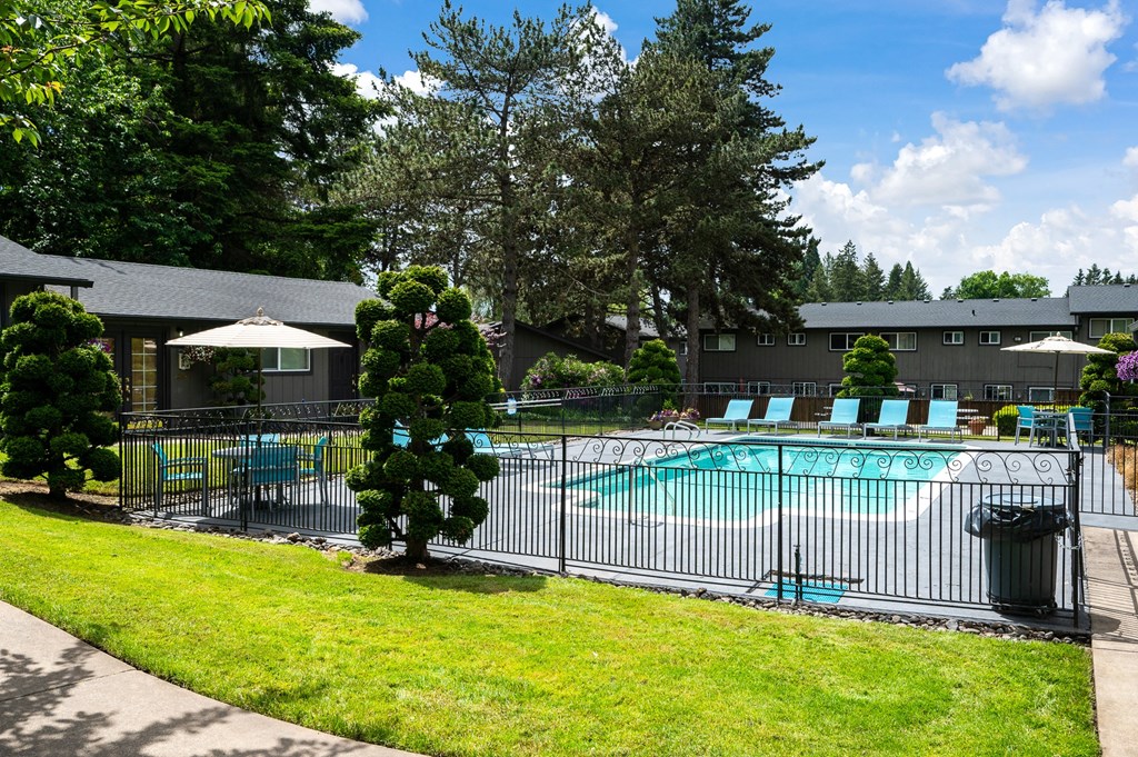 a view of a pool with a fence in front of a building