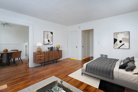 A bedroom with a bed, dresser, and mirror.