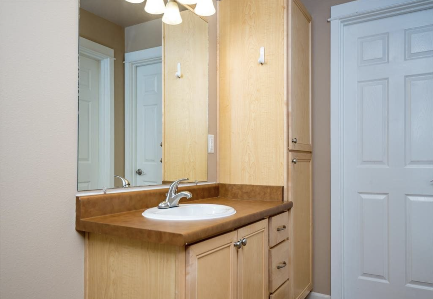 Southside Townhome | Bathroom with Wood Cabinetry and Ample Storage