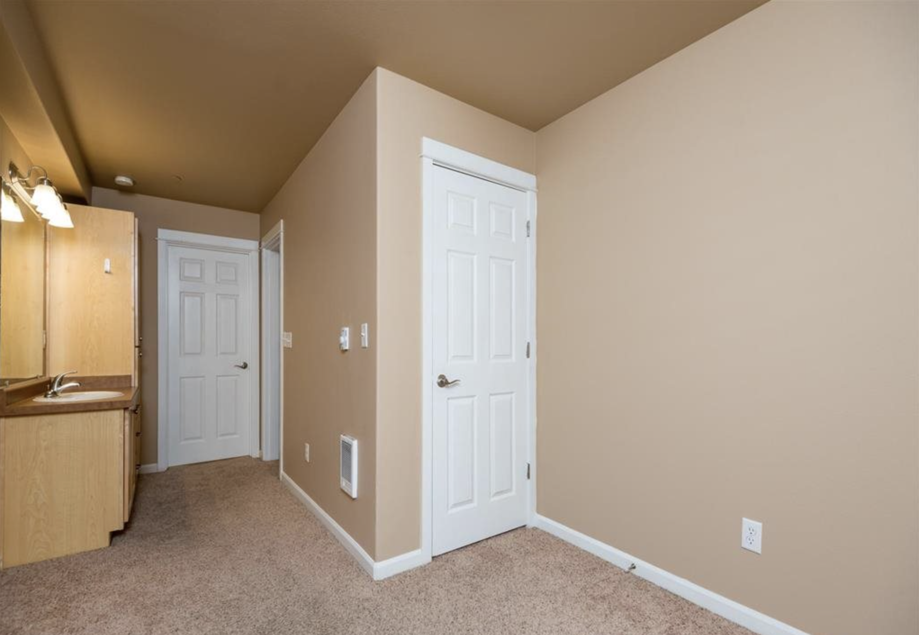 Southside Townhome | Bathroom with Wood Cabinetry and Ample Storage