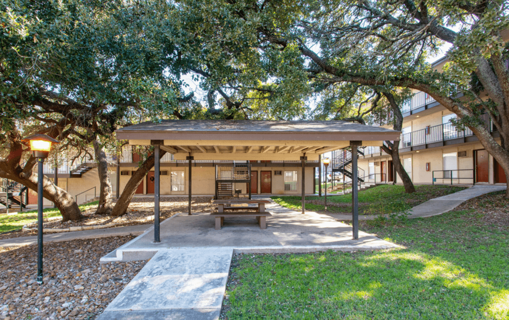 a picnic area with a picnic table under a pavilion