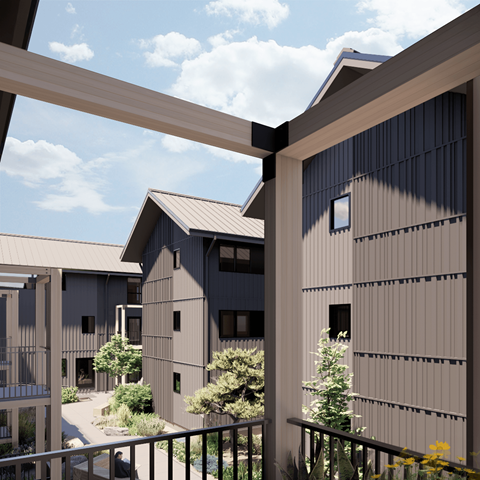 A modern building with a balcony overlooking a courtyard.