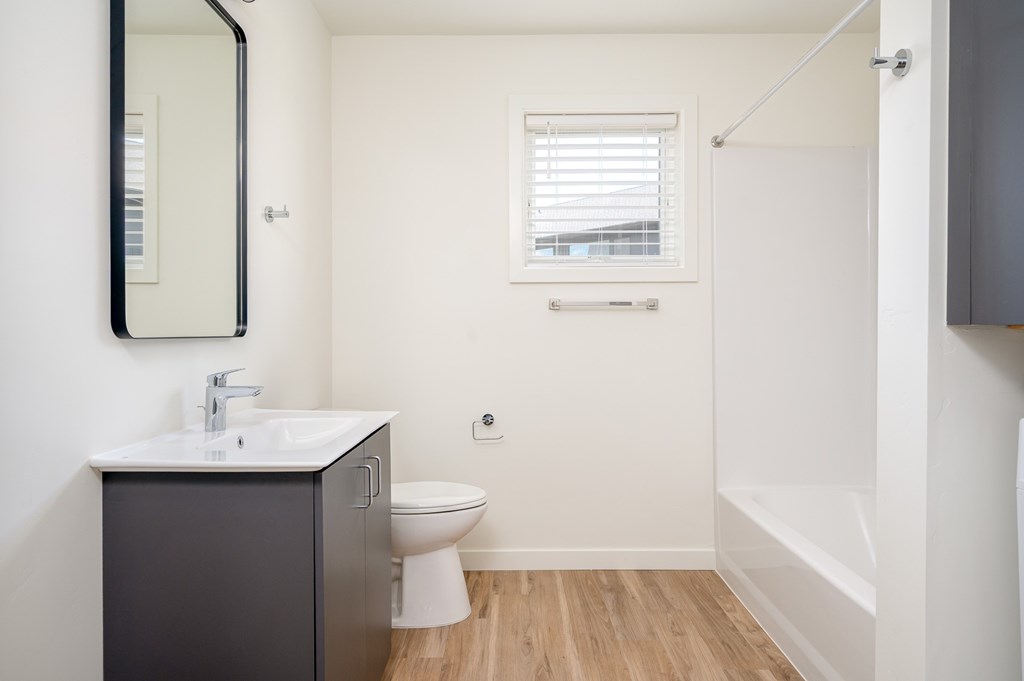 A bathroom with a sink, toilet, and bathtub.