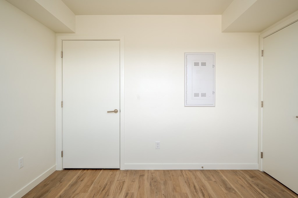 A white door is on the left and a white framed door is on the right.