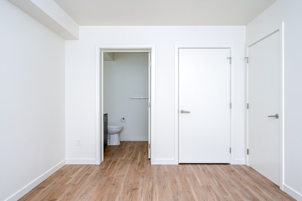 A white bathroom with a toilet and sink.