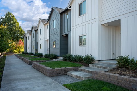 A row of modern houses with white and grey exteriors.