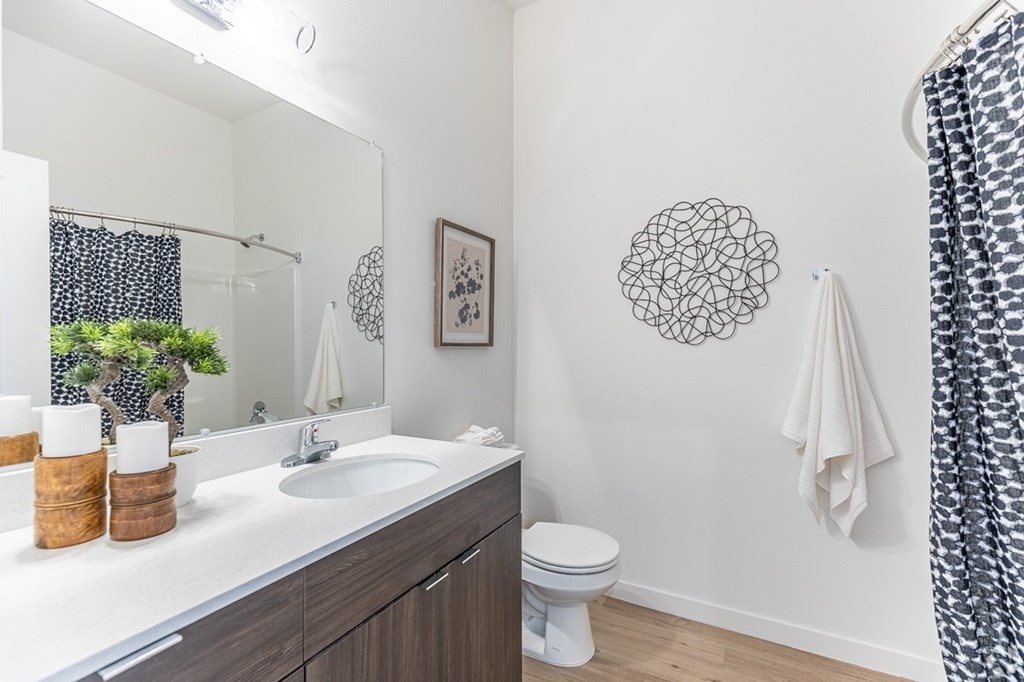 A bathroom with a white sink and a toilet.