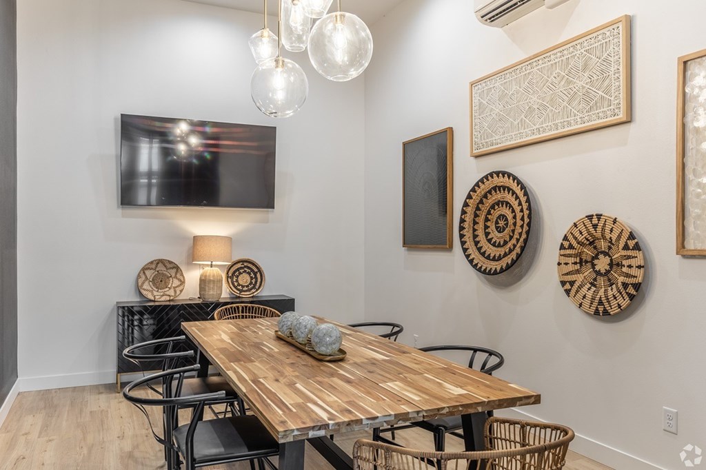 A conference  room with a wooden table and chairs.