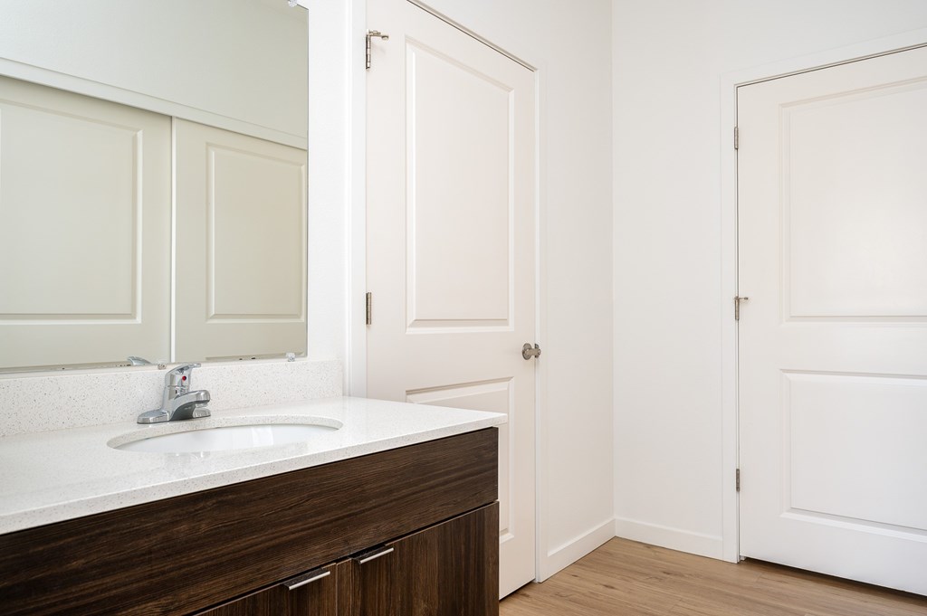 A white sink with a silver faucet in a bathroom.