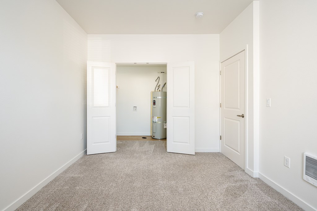 A room with a carpeted floor and white walls.