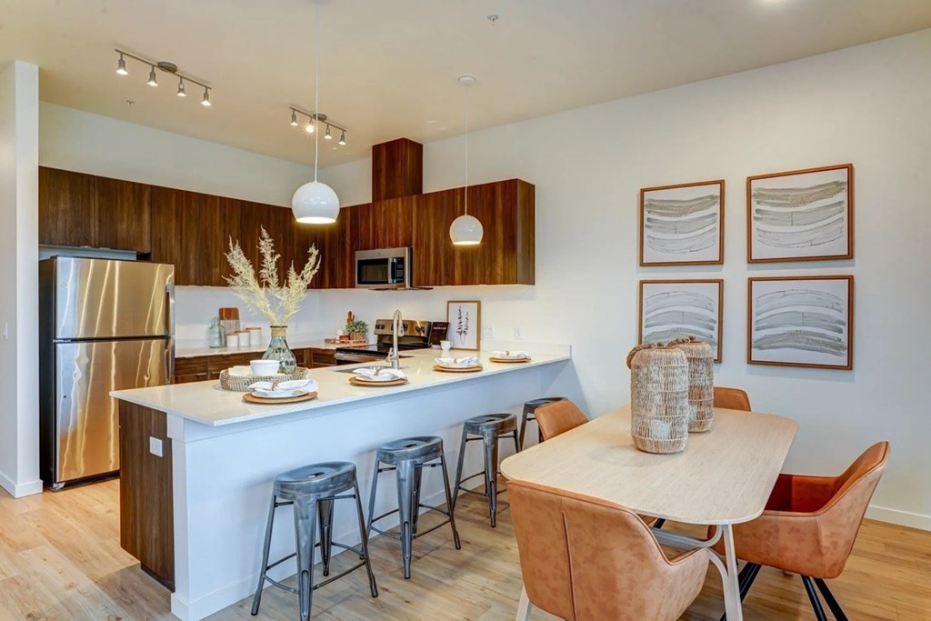 A kitchen with a white countertop and a refrigerator.