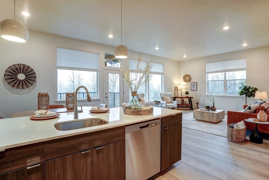 A modern kitchen with wooden cabinets and a large island.