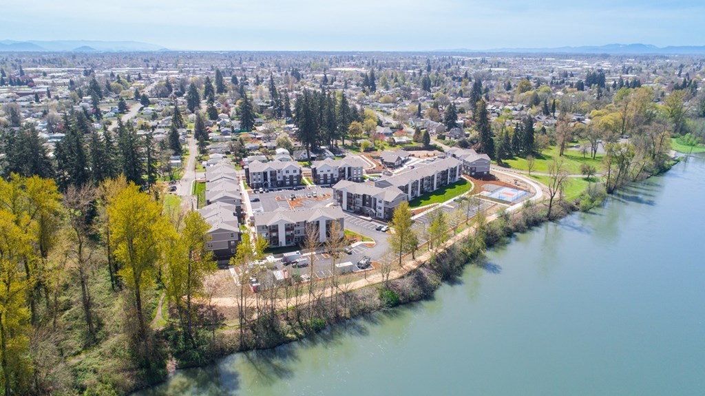 A bird's eye view of a residential area with houses and a river.