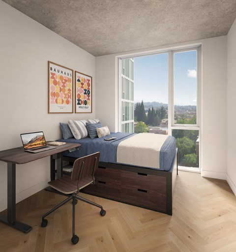 A bedroom with a bed, desk, and chair.