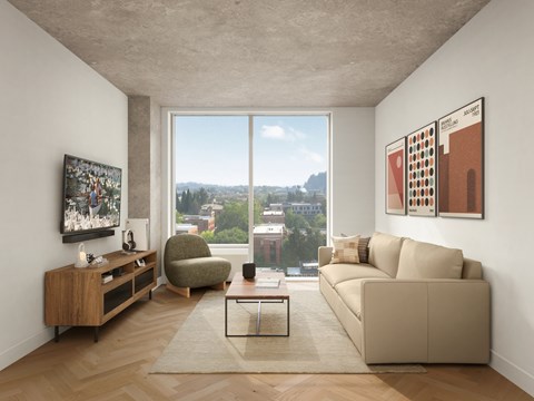 A living room with a large window and a view of the city.