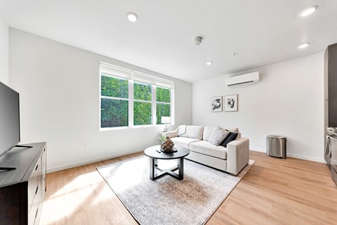 A living room with a white couch and a coffee table.