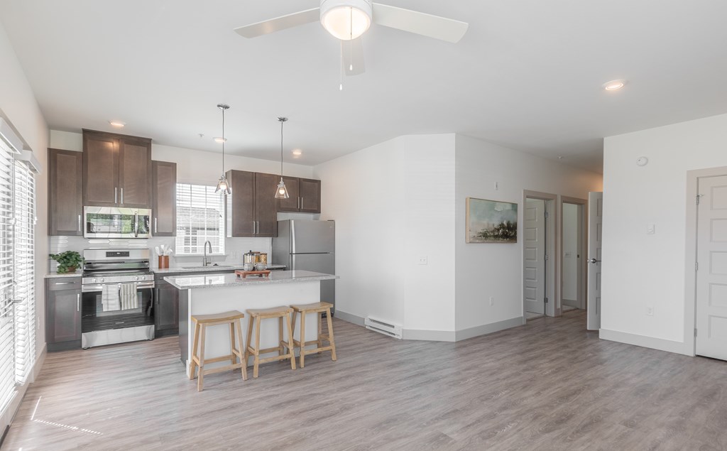A modern kitchen with a dining table and chairs.
