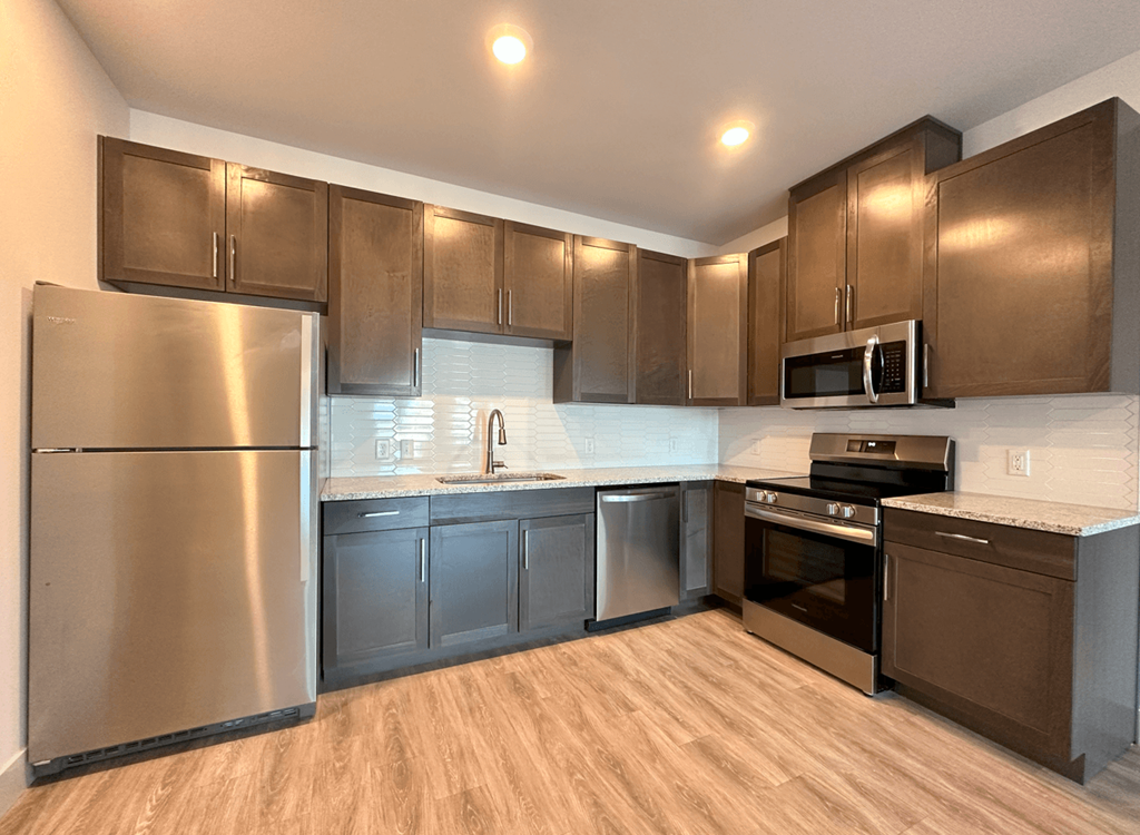 a kitchen with stainless steel appliances and wooden cabinets